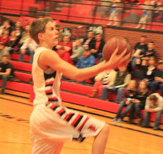 Bryson Higgins drives in for a lay-up after stealing the ball against Kamiah.