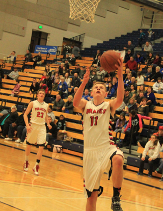 Jake Bruner goes for a lay-up after stealing the ball from Genesee. In the background is Lucas Arnzen.