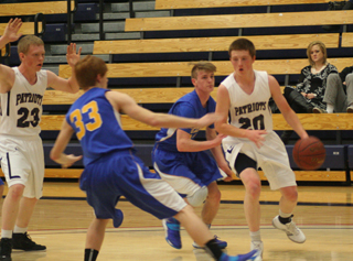 Josh Lustig handles the ball against Nezperce. At left is Nathan Beckman.
