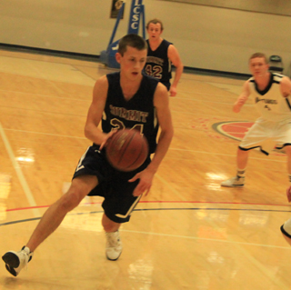 Michael Waters drives toward the key in the Deary game at District. In the background is Matthew Schwartz.