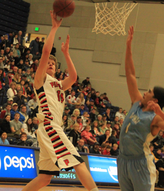 Tanner Ross puts up a shot against Lapwai in the District Championship game. He wound up as the leading scorer with 19 points.