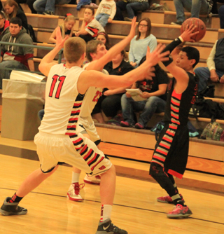 Thats a lot of long arms to try to pass the ball through as Jake Bruner and Lucas Arnzen trap a Glenns Ferry ball handler in the backcourt.