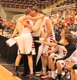 The big lead allowed Prairie to sub out their starters 1 by 1. Here coach Teel Bruner gives a hug to his lone senior starter, Jared Higgins.
