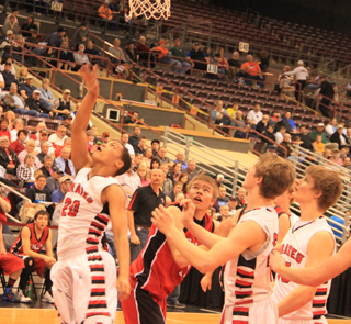 Tyler Hankerson goes for a lay-up against Challis as Lucas Arnzen and Tanner Ross watch.