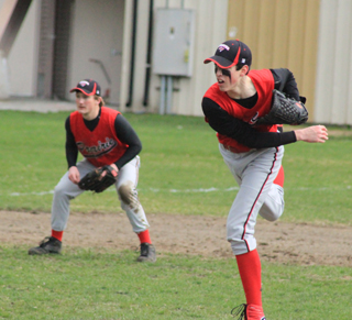 Clark Bruno delivers a pitch as third baseman Calvin Hinkelman gets ready for a possible play.