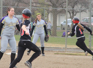 Leah Holthaus heads for second as Sky Wilson can be seen about to round third on Holthaus second game triple against Kellogg.