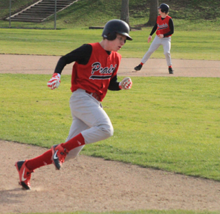 Devin Bruegeman rounds third for the first run in the opening game against Genesee. Calvin Hinkelman can be seen rounding first after his single which scored Bruegeman.