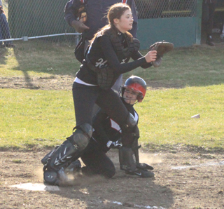 Even though the catcher has the plate blocked, Kellie Heitman was able to slide in for a run against Highland.
