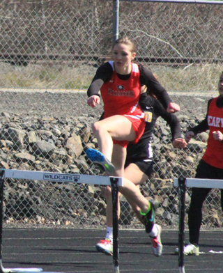 Mykaela McWilliams led the race at this point in the 300 hurdles at Lapwai but wound up 2nd to Highlands Miranda Hendren.