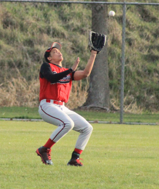 Tyler Hankerson is about to catch a fly ball in left field in the first Genesee game.