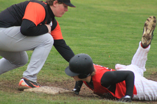 Calvin Hinkelman dives back to first on a pickoff attempt.