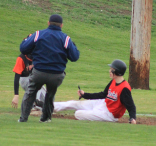 Clark Bruno slides safely into third as the throw gets away from the Troy fielder.