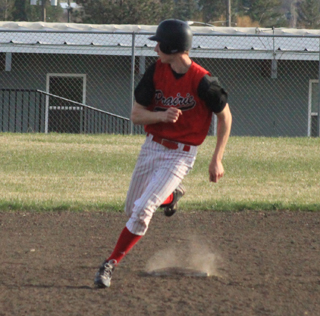 Casey Danly checks the outfield as he rounds second on an RBI single with an outfield error that gave him 2 extra bases against Kamiah. He had 3 hits in the game for the Pirates.