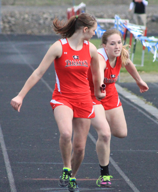 Keely Schmidt hands a lead to Mykaela McWilliams in the 4x400.