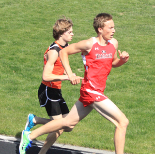 Peter Spencer takes the lead in the 3200 on the back straightaway of the final lap.