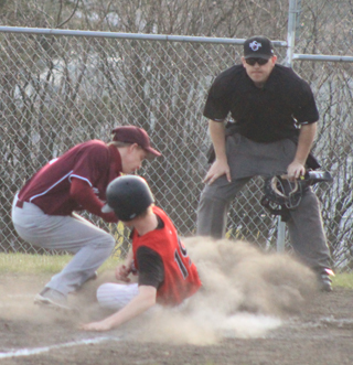 Rhett Schlader scores on a wild pitch. The umpire watching the play is Prairie alum Shawn Kaschmitter.