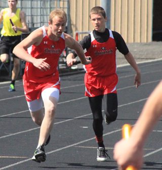 Luke Wemhoff hands off to Matt Schwartz for the final leg of the 4x200 relay.