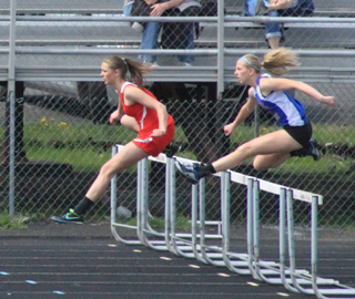 Mykaela McWilliams leads over the hurdle in the 100 hurdle race. She held off the McCall-Donnelly runner to win this event then took 2nd to the same runner in the 300 hurdles.