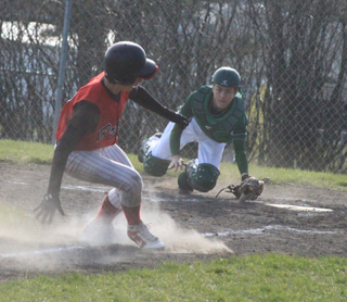 Terran Peery puts on the brakes in the first Potlatch game and turns to head back to third after he saw the throw had beaten him as he tried to score on a sacrifice fly to right. He wound up getting out of the pickle and making it safe back at third.