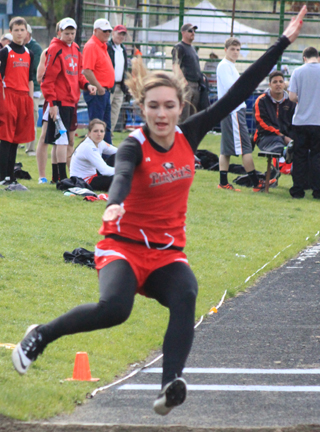 Krystin Uhlenkott soars to over 15 feet in the long jump. She won the event at the White Pine Meet Monday.