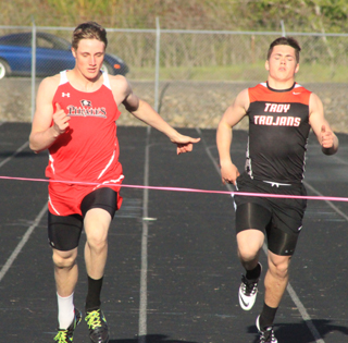 Lucas Arnzen edges Troys Zach Bafus at the finish line in the 200 at the White Pine Meet Monday. Earlier in the meet he set a new school record of 51.0 while winning the 400 meter dash.
