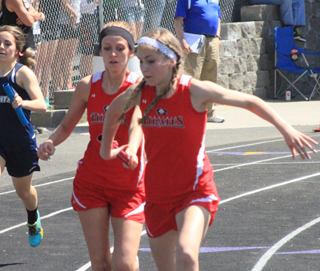 Brandi Gehring passes the baton to Chaye Uptmor in the 4x200 race at the Area Best meet.