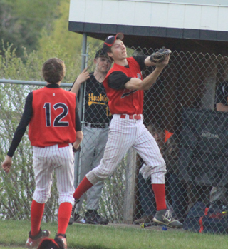 Casey Danly made a tough catch on a foul popup near the Highland dugout as pitcher Daniel Mager comes over to back up the play.