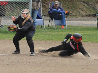 Hailey Danly slide in ahead of the throw at third against Troy.