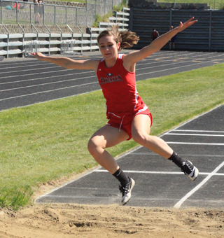 Krystin Uhlenkott spreads her wings as she flies into the pit in the triple jump.