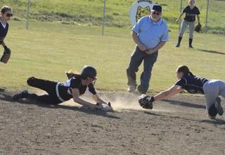 Sky Wilson grabs 2nd base as she slides past to keep herself from sliding too far on this steal against Genesee.