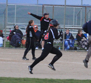 Hailey Danly sprints for second with a 2-out, 2-run double in the 2nd place game against Troy as coach Jeff Martin frantically waves a runner home in the background. The first two runs of the game scored on this play.