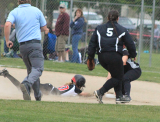 Leah Holthaus slides head first into second  with a stolen base in the first Troy game at District.