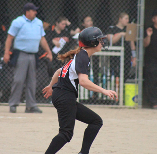 Sarah Seubert rounds first after a base hit in the first Troy game. She has become one of Prairies better hitters since getting the chance midway through the season.