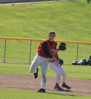 Calvin Hinkelman throws out a Wilder runner from shortstop. Behind him is Brandon Anderson who played third in this game.