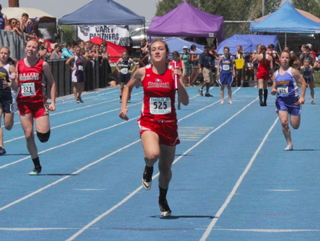 Krystin Uhlenkott brings home the baton for first place in the 4x100 relay. Shayla VonBargens back can be seen in the background.
