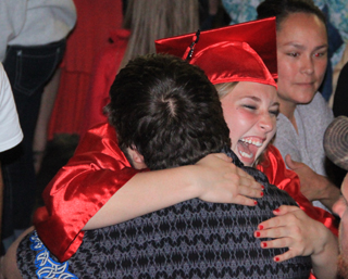 A happy Keely Schmidt gets a hug from a well-wisher.