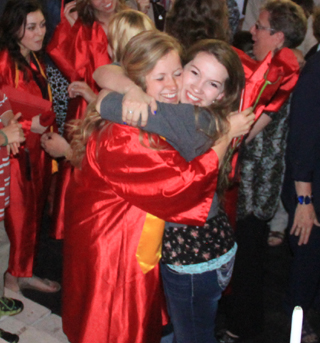Nicole Wemhoff gets a hug from former Summit Academy classmate Rachael Frei.