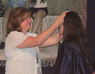 Megan Rehder receives the Excelsior Award from Gina Frei.