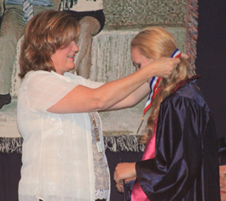 Sarah Chmelik receives the Patriot Award from Gina Frei.