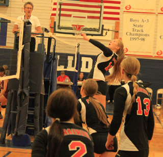 Kayla Schumacher winds up for a kill at the volleyball Jamboree. Also shown from left ate Natasha Gimmeson, Hailey Danly and Holli Uhlorn.