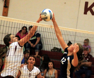 Summits Megan Seubert, right, battles a Kamiah players at the net.