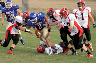 The Prairie defense gang-tackles Genesee quarterback Beau Tilleman. From left are Calvin Hinkelman, Terran Peery, Tanner Ross and Lucas Arnzen. Were not sure who the player on the ground is.