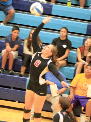 Hailey Danly leaps for a spike at Lapwai. Also shown is natasha Gimmeson.