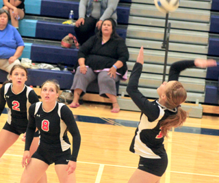 Sarah Seubert scores a back row kill against Lapwai. Also shown are Natasha Gimmeson and Hailey Danly.