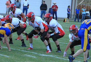 Tanner Ross snaps the ball to jake Bruner to start a play. To Ross' right is Bobby Hood. To his left is Terran Peery. Lined up in the backfield in the upper left part of the photo is Calvin Hinkelman.