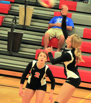 Chaye Uptmor goes for a kill from the back row as Natasha Gimmeson watches.