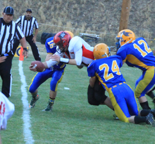 Jake Bruner fights through 3 defenders for a 2-point conversion against Salmon River.