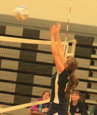 Summits Megan Seubert goes for a block against Deary.