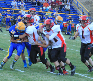 Rhett Schlader wraps up a Salmon River runner as Jake Bruner, foreground and Calvin Hinkelman, behind Bruner, move in to help.