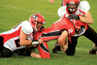 Calvin Hinkelman, left, and Lucas Arnzen combine on a tackle.
